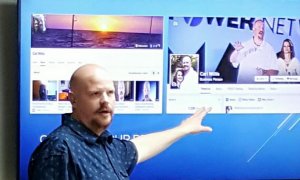 Carl Willis presenting business and marketing insights on a screen displaying social media profiles.